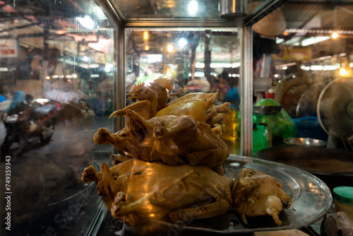 Display with whole roasted chickens in the food market in Hanoi