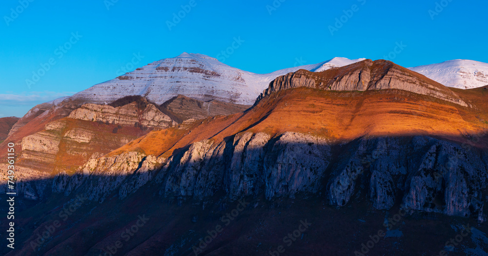 Last lights of the peaks of the Miera Valley in winter, aerial view of the Miera River Valley. Landscape in winter. Valleys Pasiegos. Cantabria. Spain. Europe