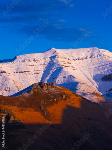 Last lights of the peaks of the Miera Valley in winter, aerial view of the Miera River Valley. Landscape in winter. Valleys Pasiegos. Cantabria. Spain. Europe