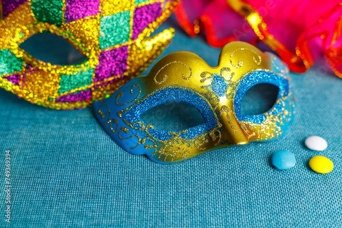 Beautiful white and multicolor carnival masks on a blue background. Purim, Mardi Gras. Top view