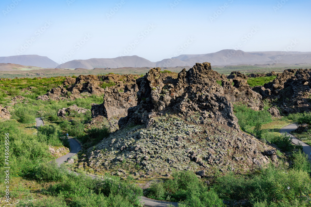 Panoramic view over the unusually shaped lava fields and rock formations of Dimmuborgir near Lake Myvatn, Icelandare which are badlands of lava pillars, caves, rugged crags and towering rocks