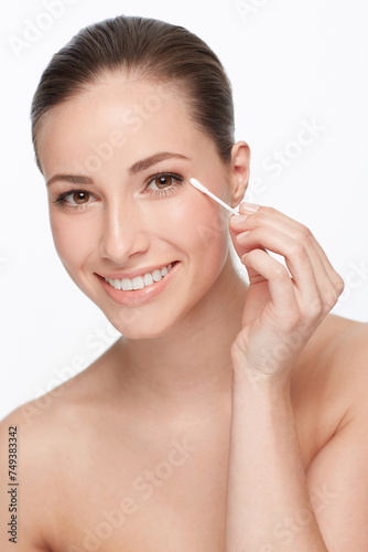 Woman, face and beauty with cotton swab for hygiene and skincare wellness, dermatology and self care on white background. Portrait, earbud and clean skin for glow and natural cosmetics in studio