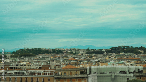 Panoramic view of several streets of Rome on a sunny day with fluffy clouds in the background, Italy