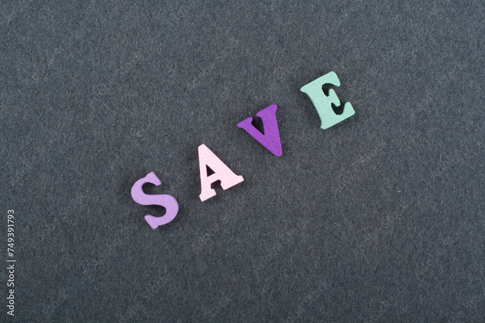 SAVE word on black board background composed from colorful abc alphabet block wooden letters, copy space for ad text. Learning english concept. SAVE word on black board background composed from colorful abc alphabet block wooden letters, copy space for ad text. Learning english concept.