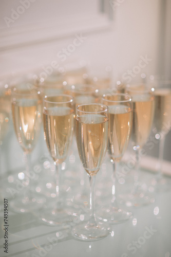 Buffet, glasses of champagne, sparkling wine, sparkling in the sun. Catering, party service. Festive event, welcome drink