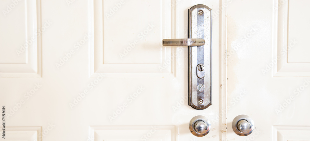 Panorama metal entrance door with rustic keyed entry door handle at apartment in Hanoi, standard door handle with knob lock rotate to operate the latch and open the door, residential house