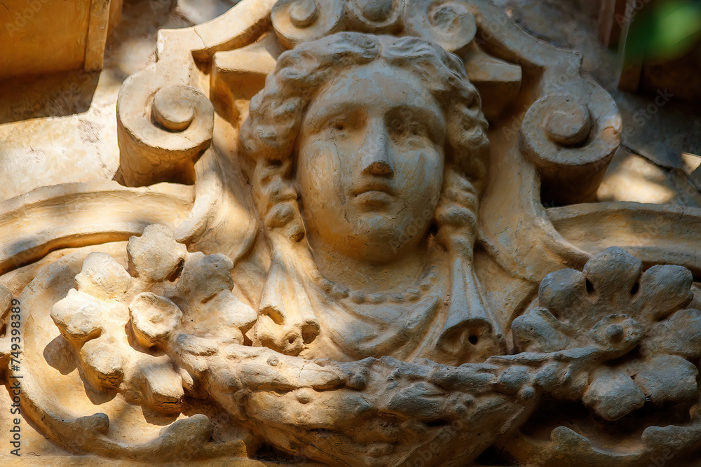 face ornament on old building facade