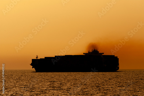 Big - A huge Container Ship enters the Suez Canal from the Mediterranean Sea at dusk. 