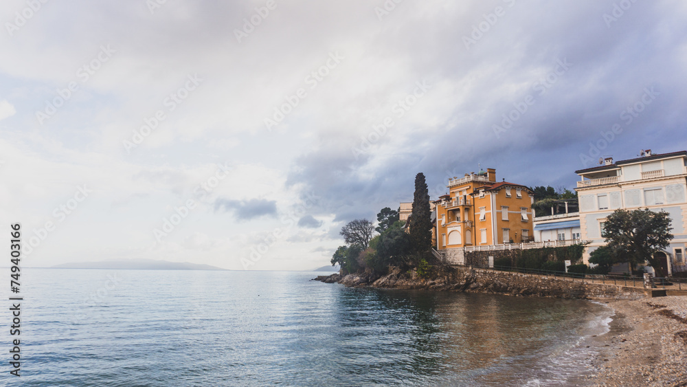 Idyllic house in the cliff with a beach beneath it on a stormy day in Rijeka, Croatia.