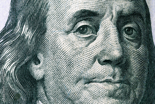 Benjamin Franklin's face on a hundred dollar bill. United States national currency banknote fragment. Benjamin Franklin portrait photo