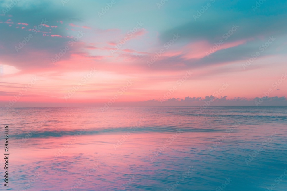 a body of water with a pink and blue sky