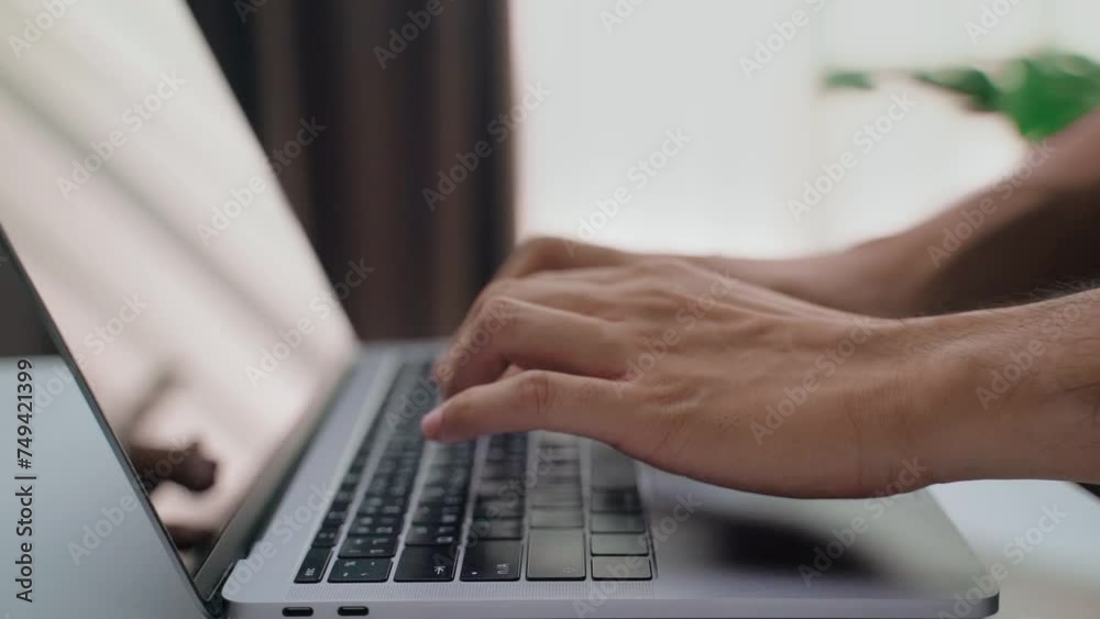 Close-up of man's hands typing on the laptop computer keyboard for work at home. Work from home concept. Close-up of man's hands typing on the laptop computer keyboard for work at home. Work from home concept.