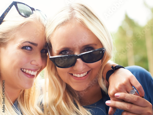 Portrait, women and happy friends hug outdoor for care or bonding together in summer. Face, sunglasses and girls embrace for connection, relationship and smile of young people having fun in nature