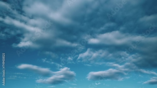 Tropical summer sunlight. White and blue cumulus and cirrocumulus on different layers clouds background. Tropical summer morning bright sunlight. photo