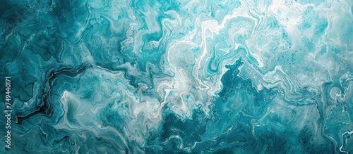 Marbling background with paint swirls in beautiful teal, blue, and white colors.