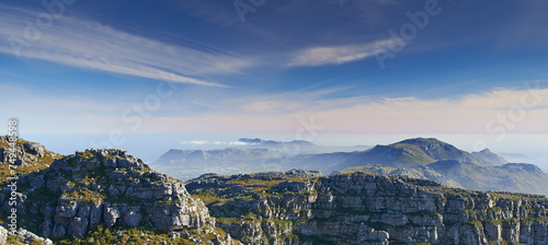 Mountain, clouds and blue sky with horizon, natural landscape and calm cliff at travel location. Nature, fog and sustainable environment with earth, peace and holiday destination at tropical island