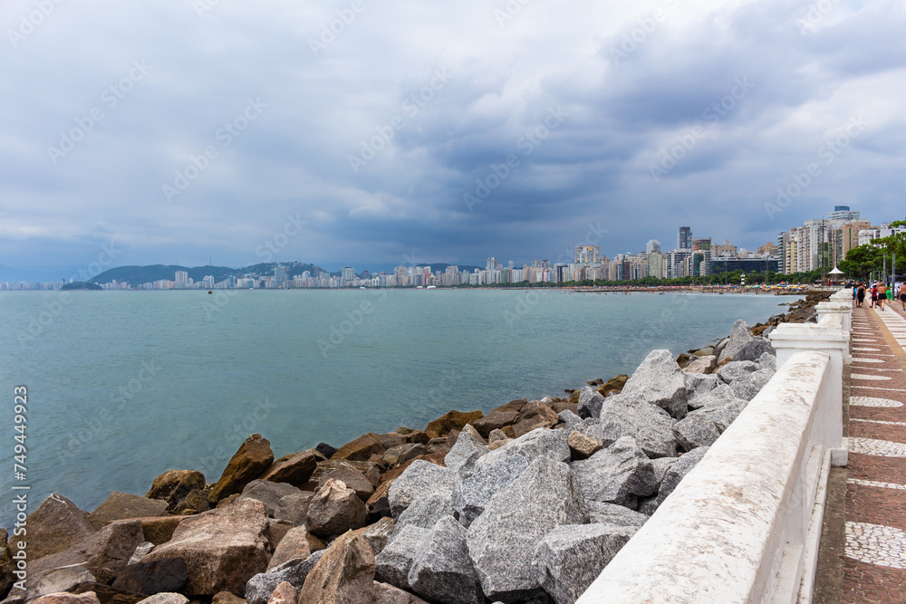 SANTOS, SP, BRAZIL - JANUARY 02, 2024: View of the city's beautiful waterfront with its historic wall separating the promenade.