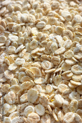 Close up photo of barley flakes, selective focus, food background.