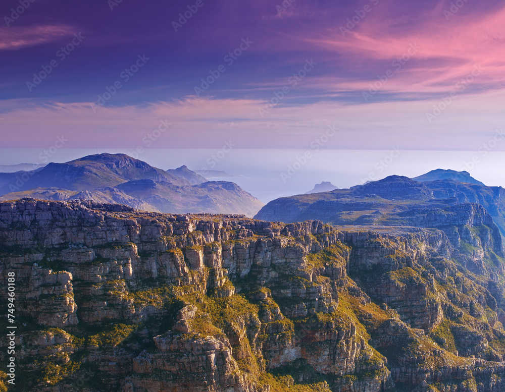 Mountain, clouds and sunset sky with color on horizon, natural landscape and cliff at travel location. Nature, hill and sustainable environment with earth, peace and destination at tropical island