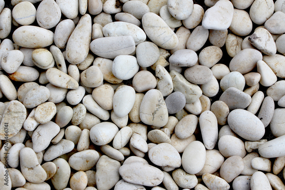 A pile of smooth, oval, matte, white, textured pebbles, perfect for a background A pile of smooth, oval, matte, white, textured pebbles, perfect for a background