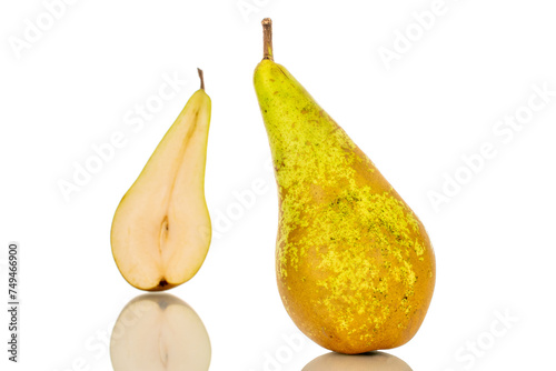 One whole and one half green pear, macro, isolated on white background.