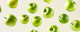Green Apples Suspended in Air on a Light Cream Background