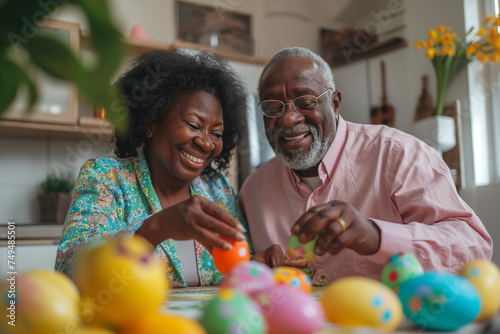 An African-American elderly couple paints eggs for Easter photo