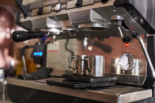 Close up background image of shiny metal cups ready for shesh coffee in coffee machine copy space