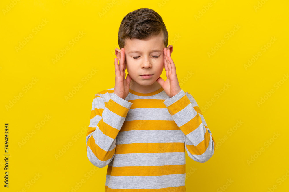 Little caucasian boy isolated on yellow background with headache Little caucasian boy isolated on yellow background with headache