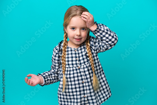 Little caucasian girl isolated on blue background with surprise and shocked facial expression