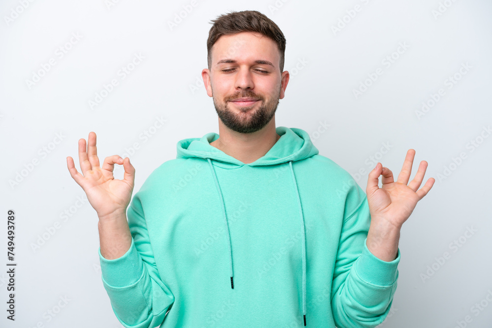 Young caucasian man isolated on white background in zen pose Young caucasian man isolated on white background in zen pose