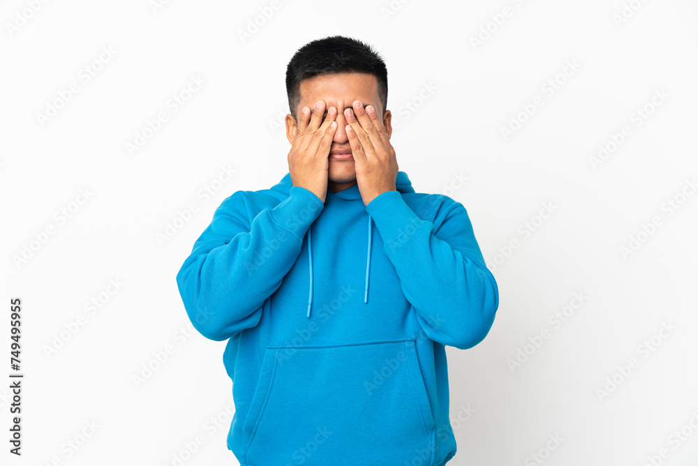 Young Ecuadorian man isolated on white background covering eyes by hands Young Ecuadorian man isolated on white background covering eyes by hands