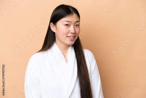 Young Chinese woman isolated on beige background . Portrait