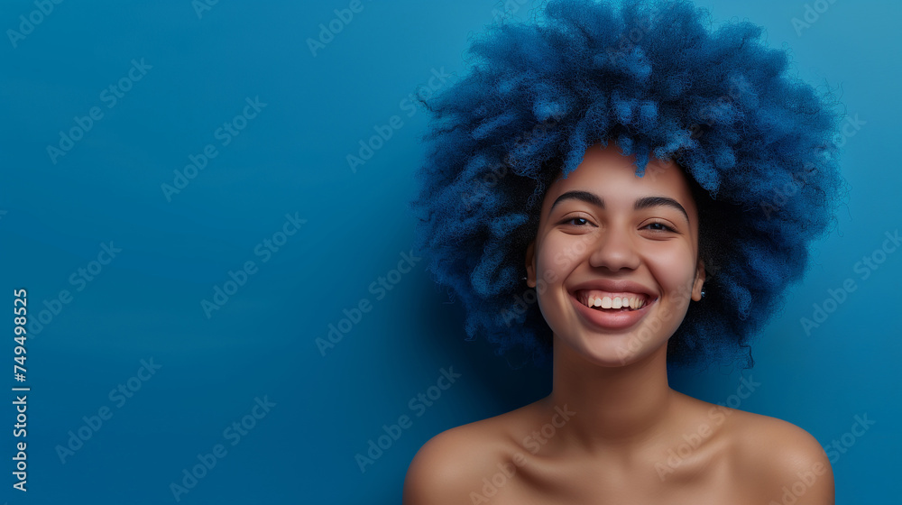 Portrait of african american young female in casual cloth with afro hairdo on blue background