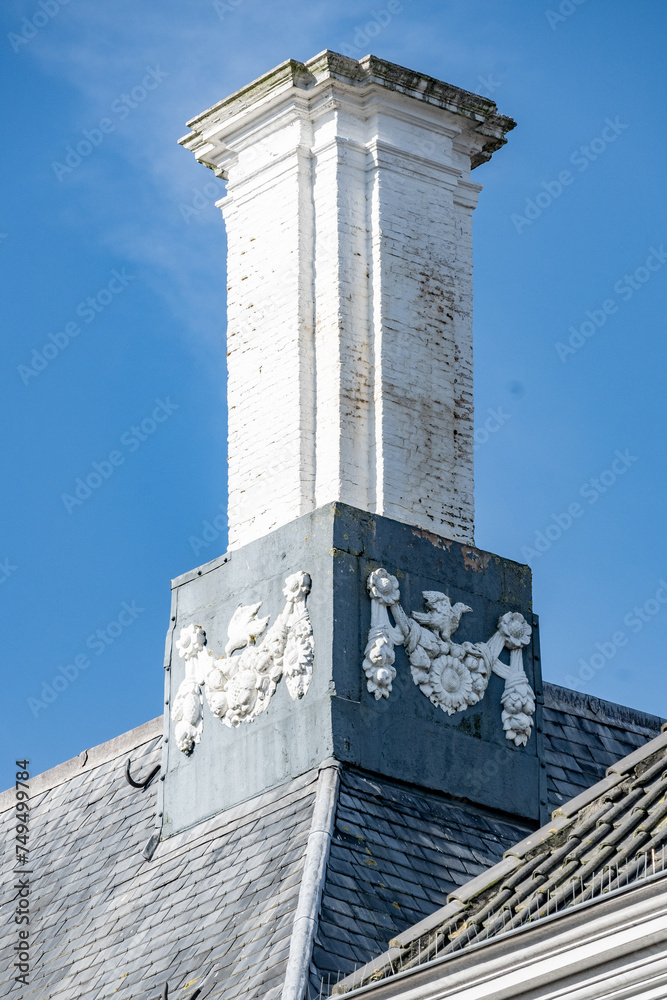 Old brick and decorated chimneys on the roof