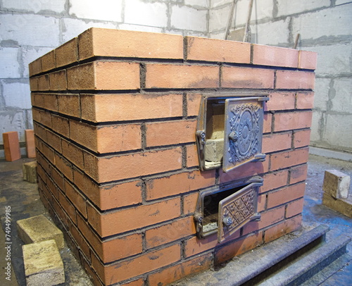 construction of brick ovens. brick stove for sauna. heating stone stove.