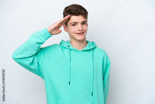 Teenager Russian man isolated on white background saluting with hand with happy expression © luismolinero