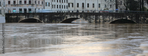 almost submerged arches of the Old Bridge called Ponte Pusterla in the city of Vicenza in northern Italy during the flood with the Bacchiglione river