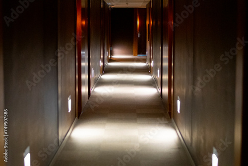 Hotel and building corridor in the dark with several lights with doors 