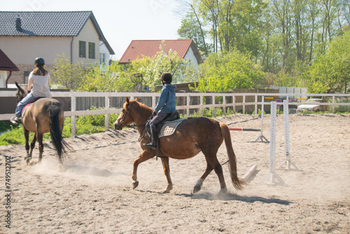 boy riding a brown horse