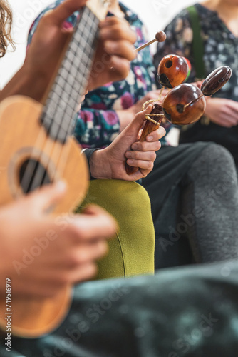 Group of people playing on different kinds of musical instruments during music therapy
