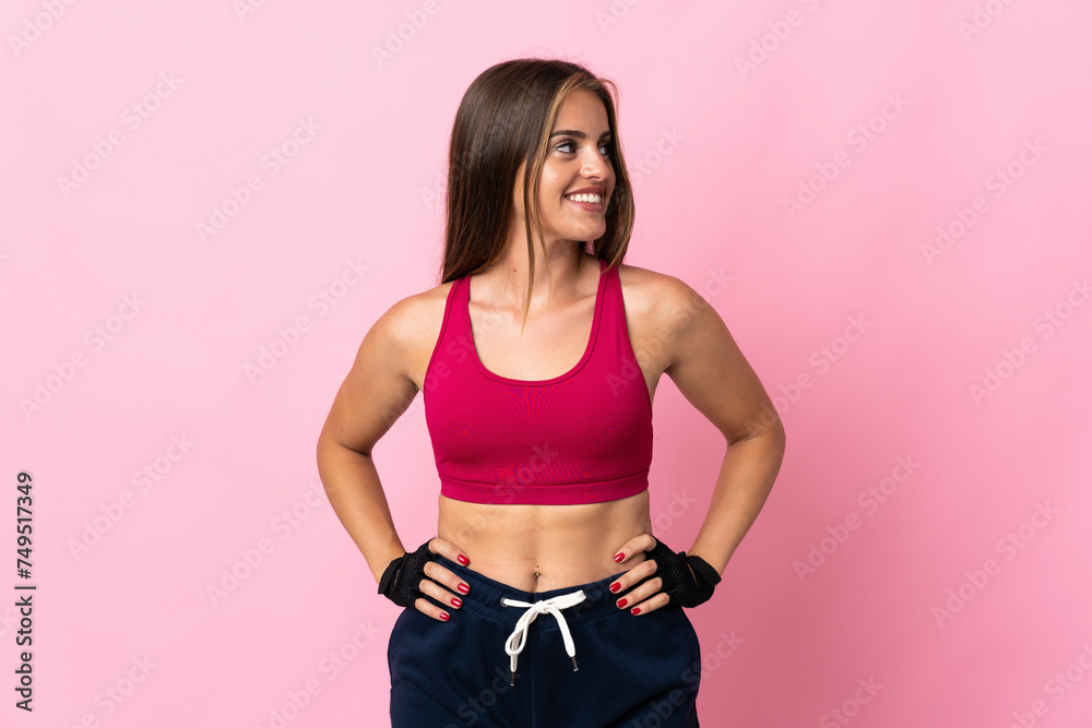 Young Uruguayan woman isolated on pink background posing with arms at hip and looking side Young Uruguayan woman isolated on pink background posing with arms at hip and looking side