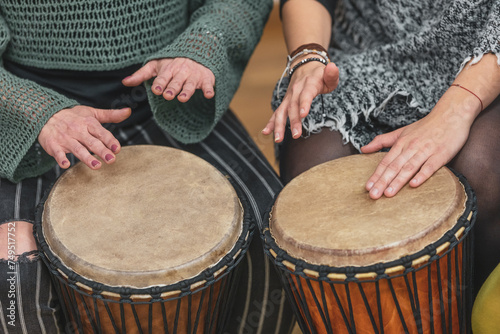 Group of people playing drums during a music therapy lessons, jembe drum, drumming concept