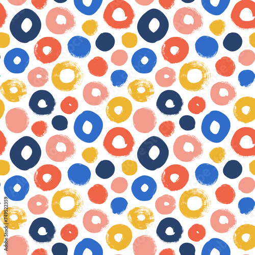 Colorful geometric seamless pattern with various circles and dots. Naive childish style wallpaper.