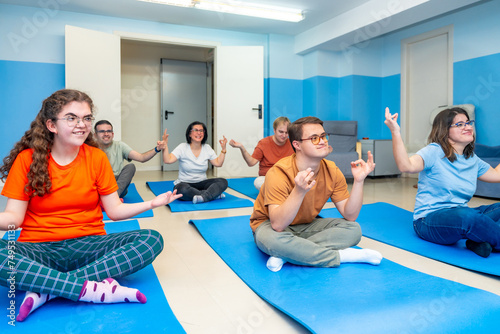 Disabled people practicing lotus pose during yoga class