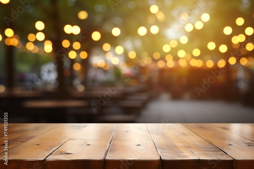 The empty wooden table top with a blurred background of a restaurant or cafe with bokeh