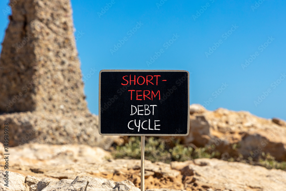 Short-term debt cycle symbol. Concept words Short-term debt cycle on beautiful black chalk blackboard. Beautiful stone blue sky background. Business Short-term debt cycle concept. Copy space