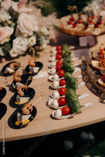 Food, a beautifully decorated catering banquet table with a variety of appetizers with cheese, ham, prosciutto and fruit. At a corporate, Christmas, birthday or wedding celebration. Buffet table. Buff