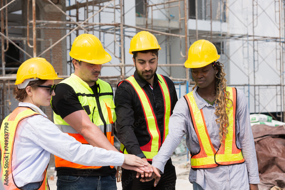 Group of male and female engineer construction working and join hands together at construction site. Foreman construction working at construction site Group of male and female engineer construction working and join hands together at construction site. Foreman construction working at construction site