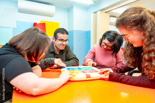 Slika na platnu Group of disabled people playing board games together